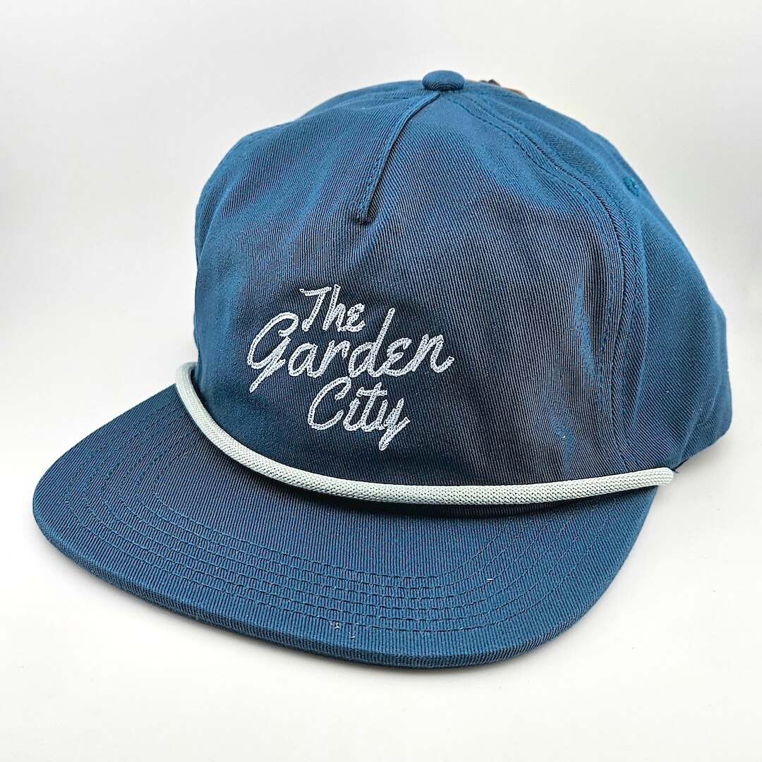 Blue cap with 'The Garden City' text on a white background