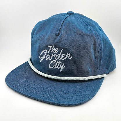 Blue cap with 'The Garden City' text on a white background