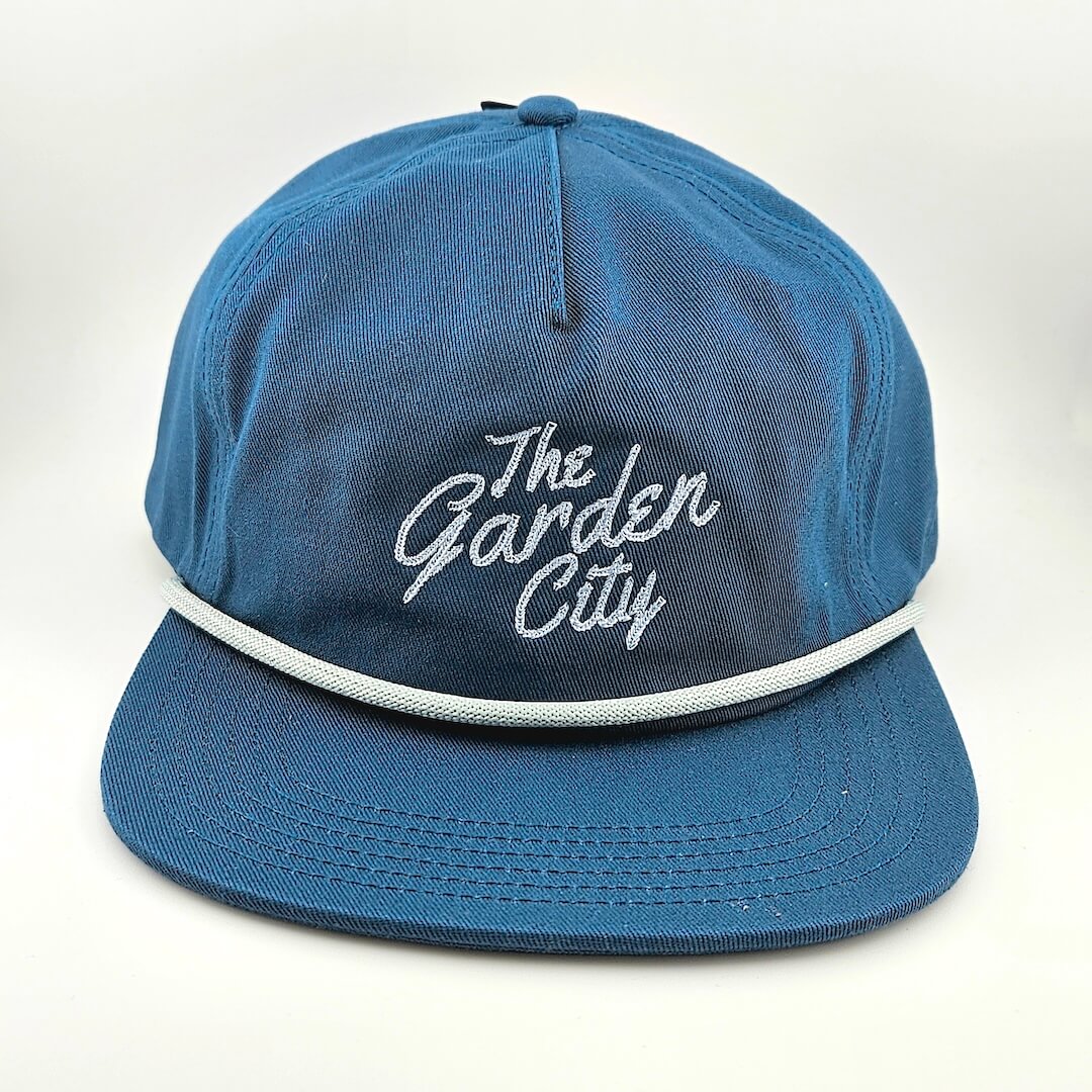 Blue cap with 'The Garden City' text on a white background