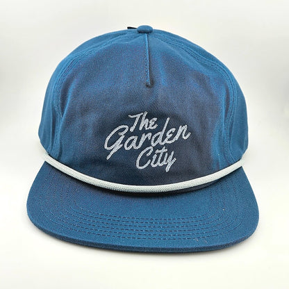 Blue cap with 'The Garden City' text on a white background