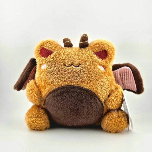 Brown winged plush animal with horns and tag against white background.