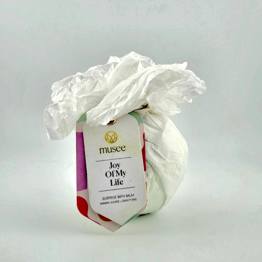 Bath balm with a decorative paper sleeve labeled 'musee Joy Of My Life' on a light gray background