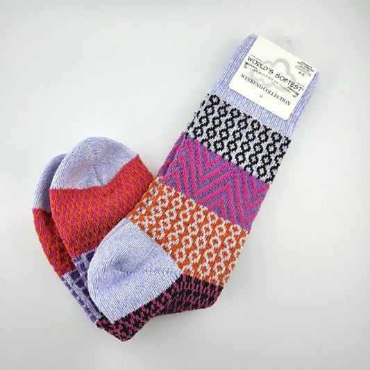 Pair of brightly colored socks with visible brand label against light gray background.