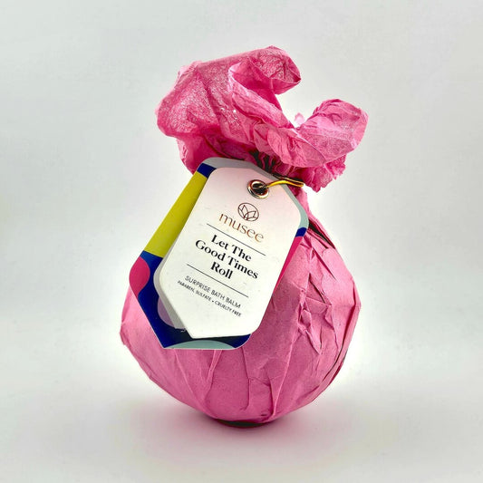 Pink wrapped product with a colorful tag on a white background