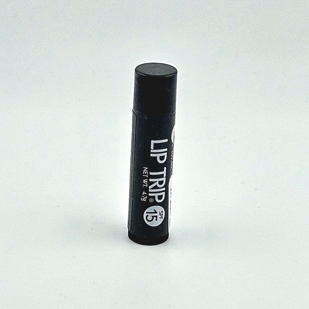 Black lip balm tube labeled 'Lip Trip' on a white background