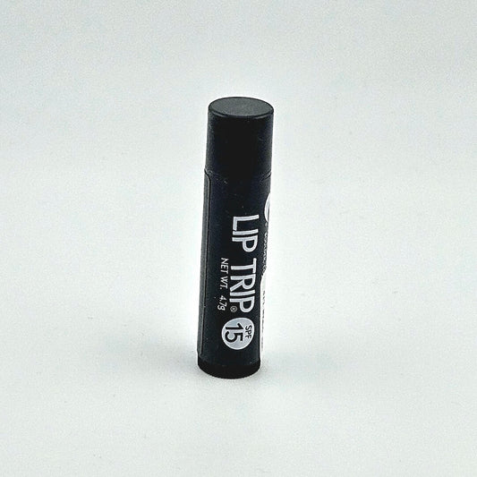 Black lip balm tube labeled 'Lip Trip' on a white background