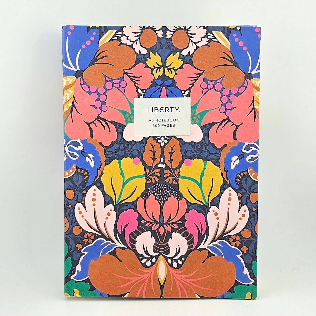 Colorful floral notebook with 'Liberty' branding on a white background