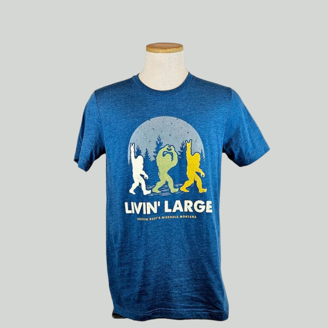 Blue t-shirt with three Bigfoot graphic design on a mannequin against a white background