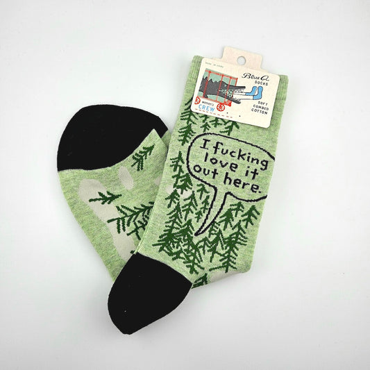 Green socks with text and leaf pattern on a white background