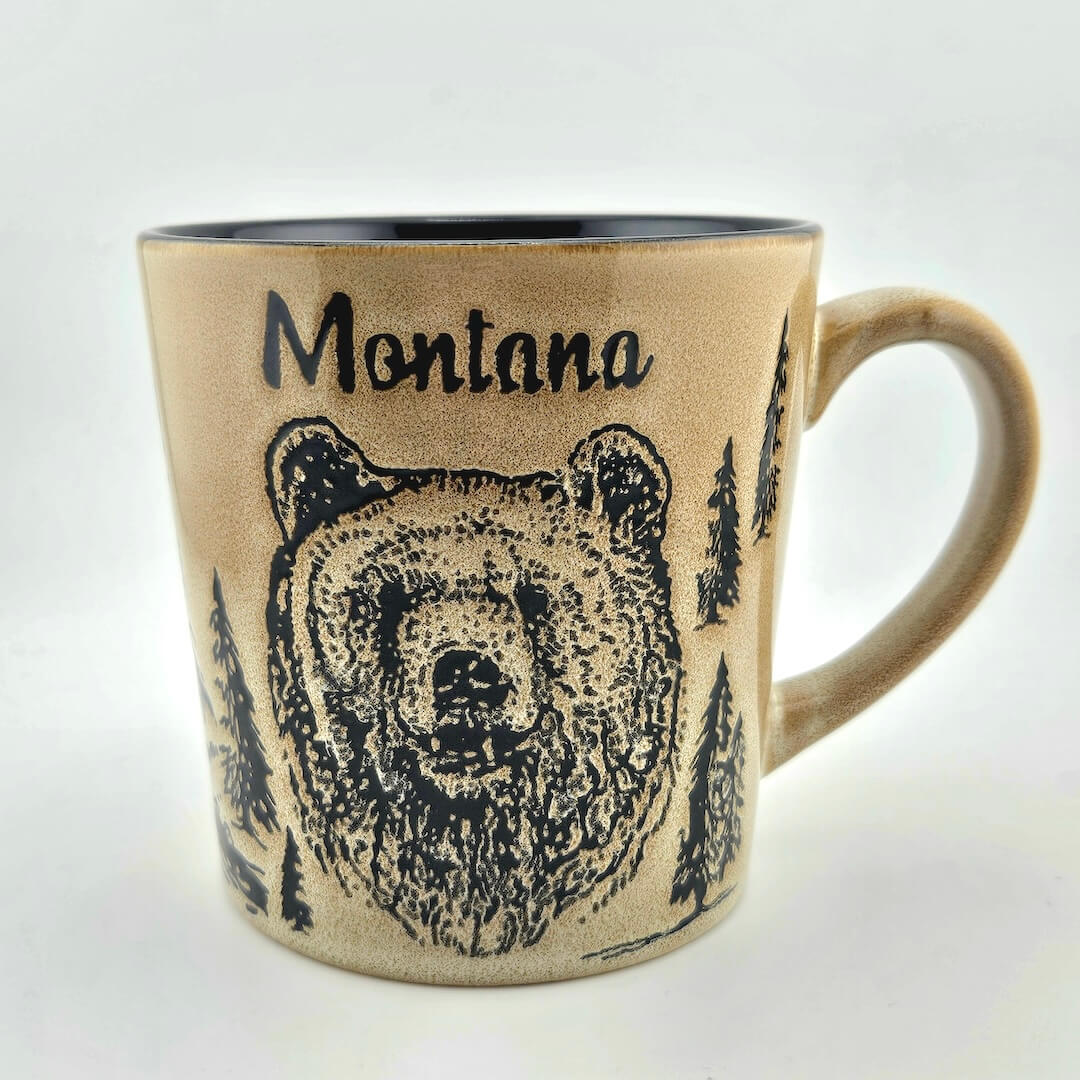 Mug with bear design and 'Montana' text on a beige background