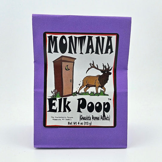 Purple paper bag; white label has image of elk outside outhouse framed by product information. 