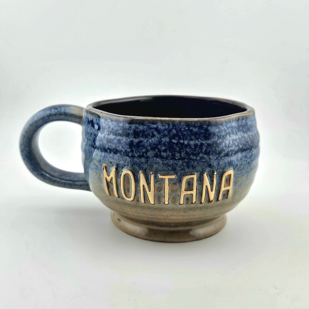 Blue speckled mug with 'Montana' on a white background