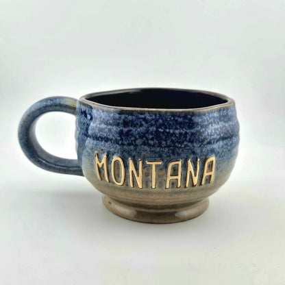 Blue speckled mug with 'Montana' on a white background