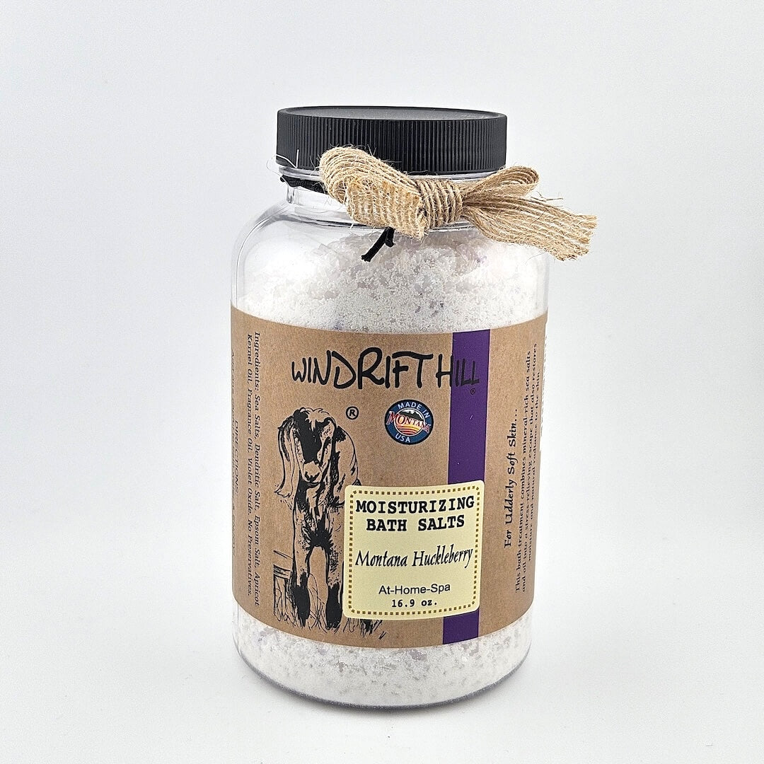 Jar of Windrift Hill bath salts with a decorative ribbon on a gray background