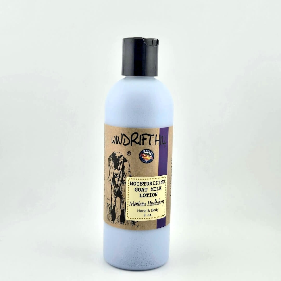 Plastic bottle of Windrift Hill moisturizing goat milk lotion on a gray background