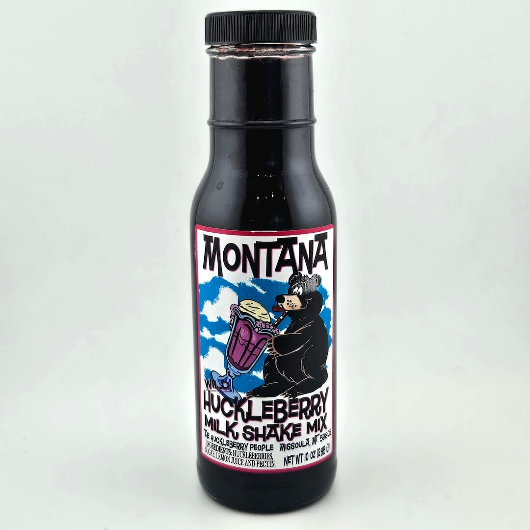 bottle with black lid, label with image of bear sipping a milkshake through a straw among product details in black print. 