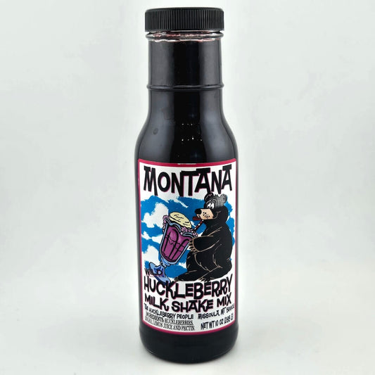 bottle with black lid, label with image of bear sipping a milkshake through a straw among product details in black print. 