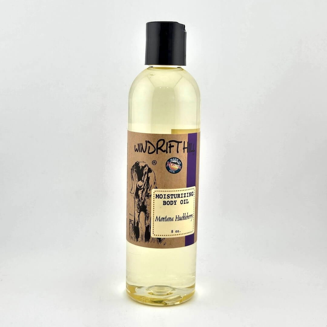 Plastic bottle of Windrift Hill moisturizing body oil on a gray background
