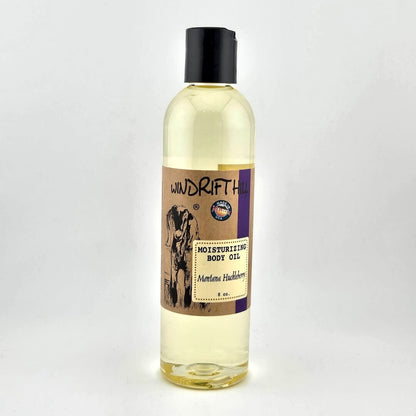 Plastic bottle of Windrift Hill moisturizing body oil on a gray background