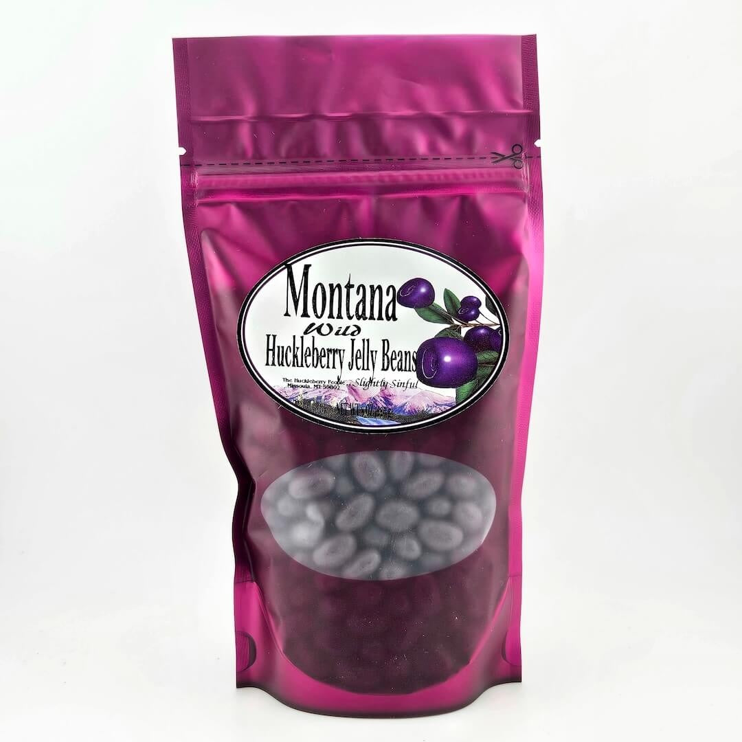 Pink packaging of Montana Huckleberry Jelly Beans with a visible brand label on a white background