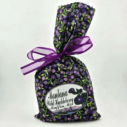 Huckleberry patterned fabric bag with purple ribbon bow, label has enlarged huckleberry image & product info.
