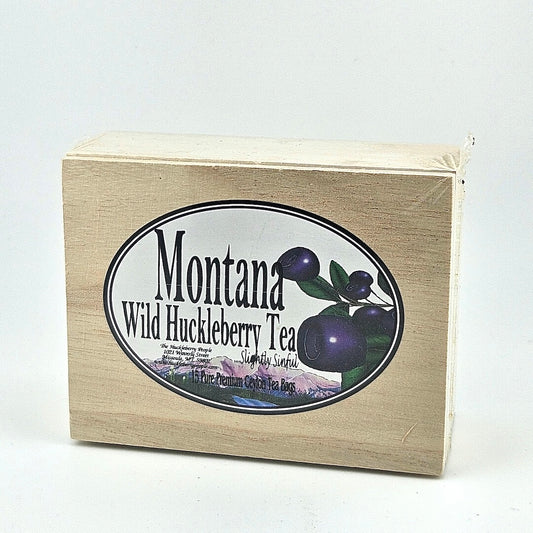 Plastic sealed wooden box with oval white label in center. Label has enlarged huckleberries image to right of product info.