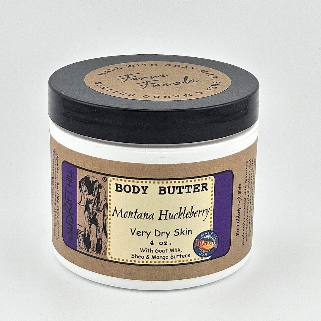 Jar of Montana Huckleberry body butter on a gray background