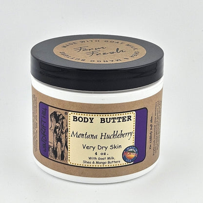 Jar of Montana Huckleberry body butter on a gray background
