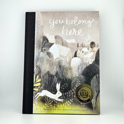 Hardcover book with artistic landscape illustration as cover