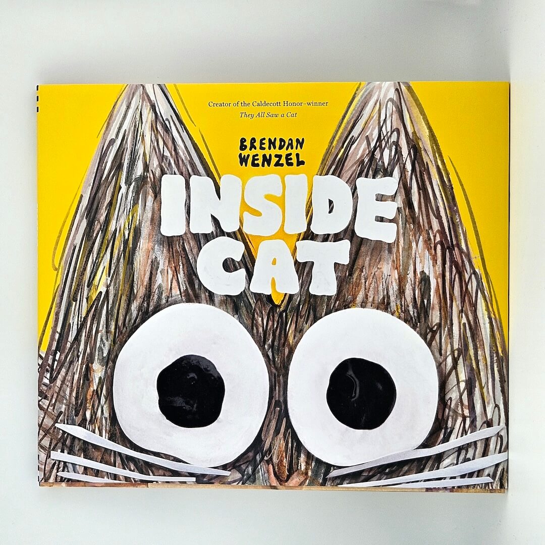 yellow hardcover book titled "Inside Cat" by Brendan Wenzel against white background.