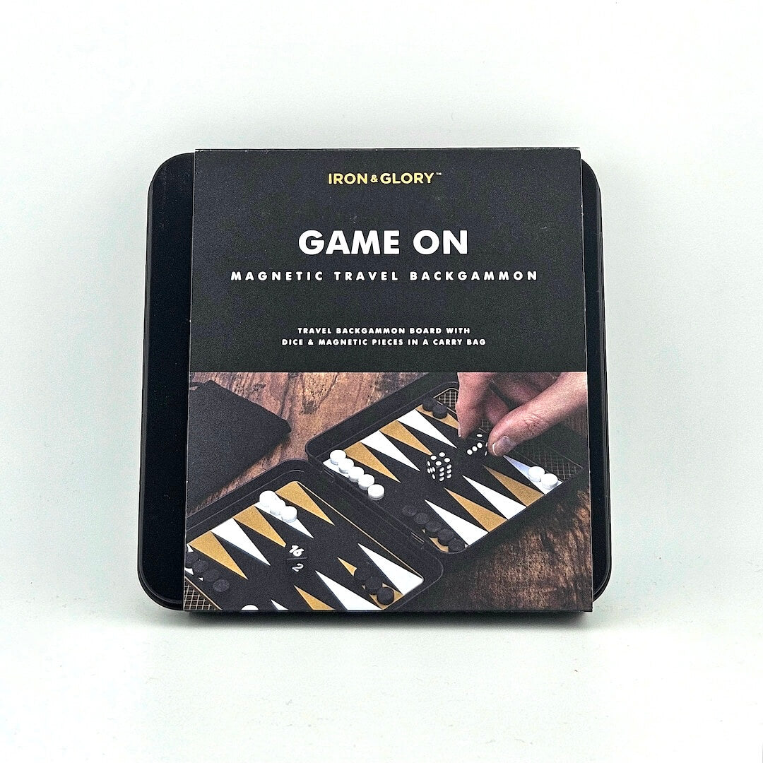Magnetic travel backgammon set packaging with 'Iron & Glory' branding on a white background