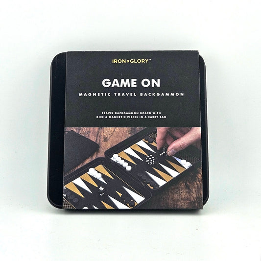 Magnetic travel backgammon set packaging with 'Iron & Glory' branding on a white background