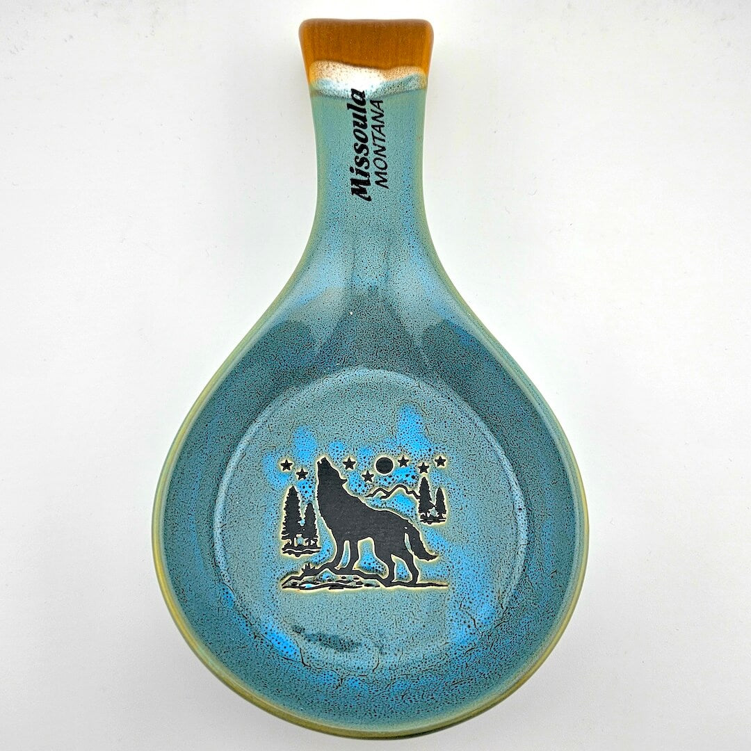 Ceramic spoon rest with wolf design and 'Missoula Montana' text on a white background