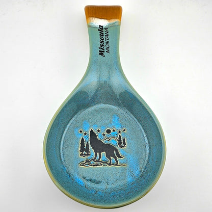 Ceramic spoon rest with wolf design and 'Missoula Montana' text on a white background