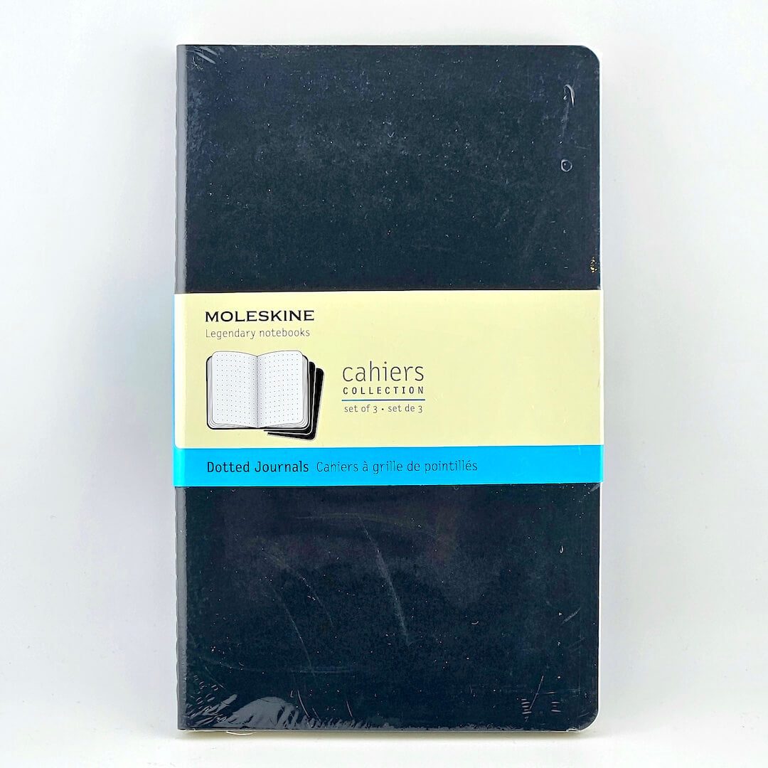 Moleskine notebook with a yellow label on a white background