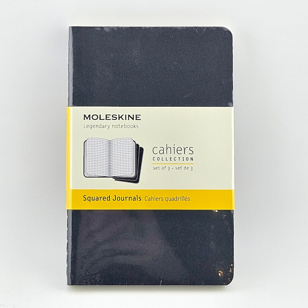 Moleskine notebook with a yellow label on a white background