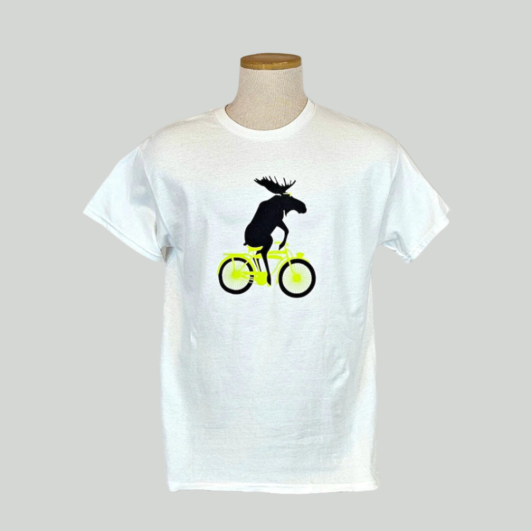 White t-shirt with a moose riding a bicycle graphic on a mannequin against a white background