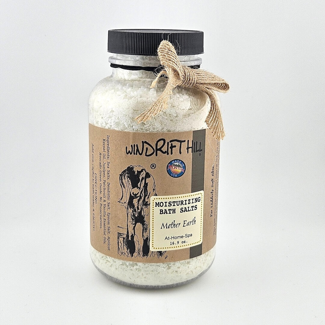 Jar of Windrift Hill bath salts with a decorative ribbon on a gray background