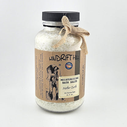 Jar of Windrift Hill bath salts with a decorative ribbon on a gray background