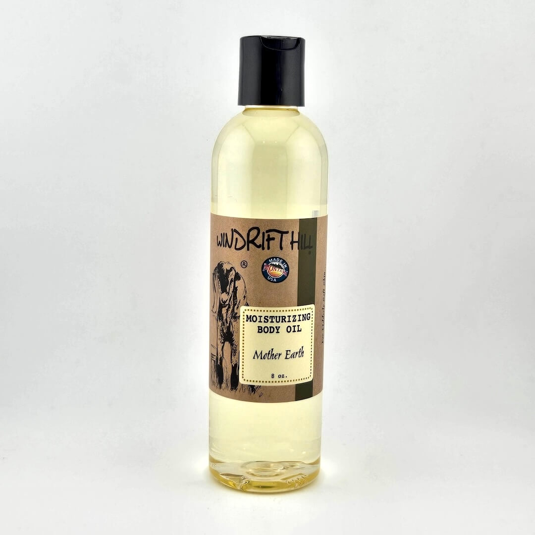 Plastic bottle of Windrift Hill moisturizing body oil on a gray background