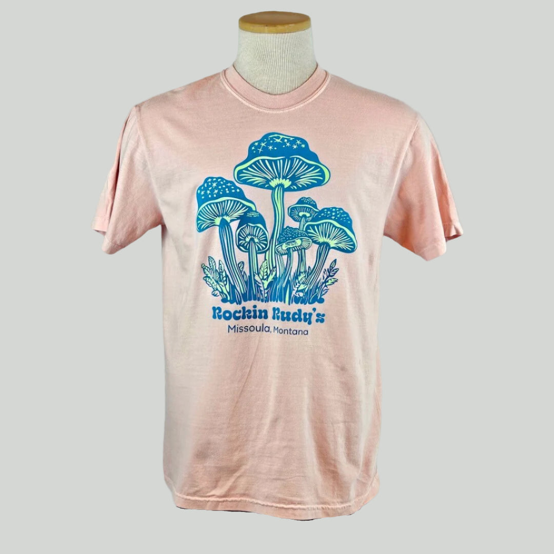 Pink t-shirt with blue mushroom graphic on a mannequin against a white background