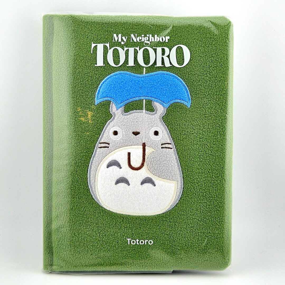 Green plush notebook with Totoro design and 'My Neighbor Totoro' text on a white background