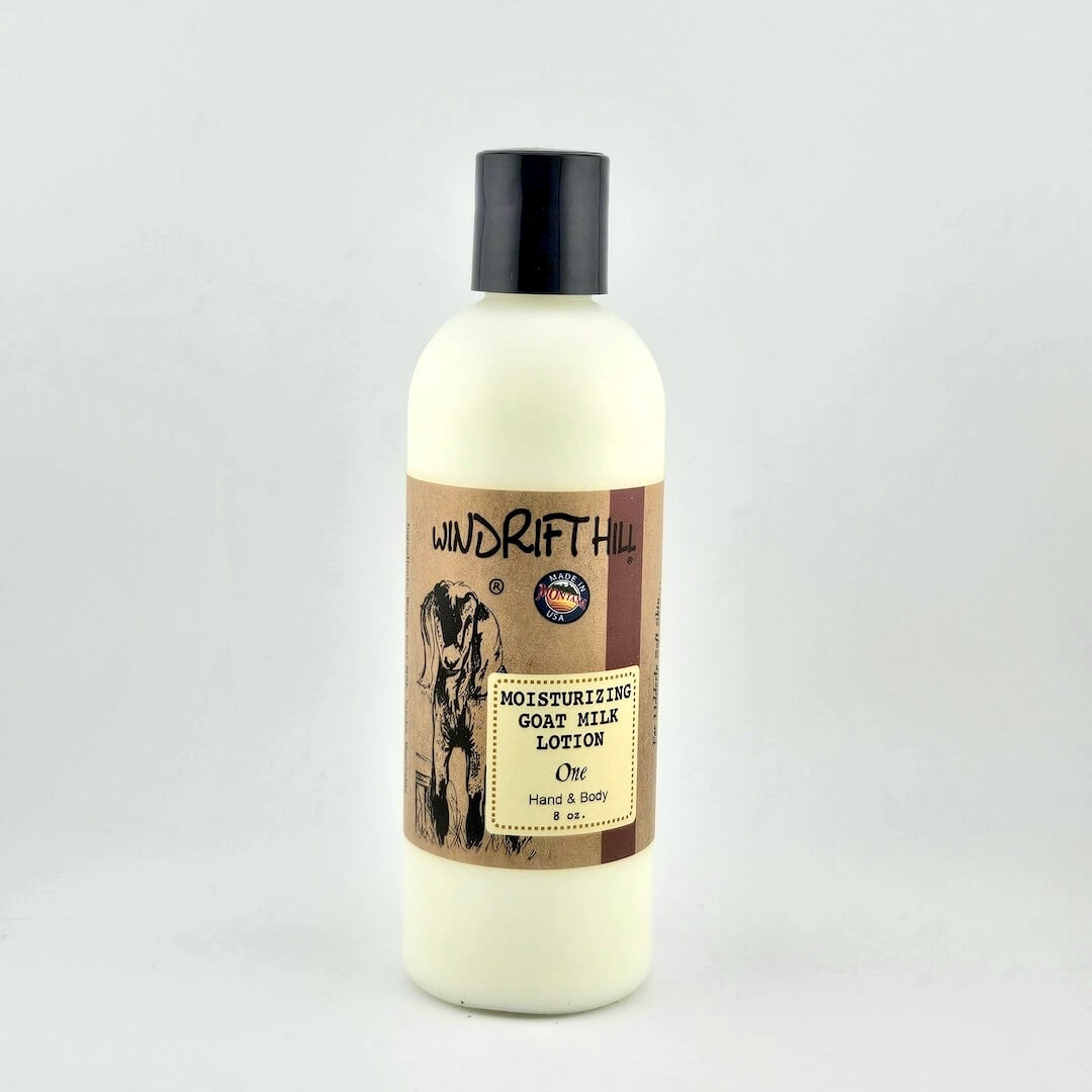 Plastic bottle of Windrift Hill moisturizing goat milk lotion on a gray background