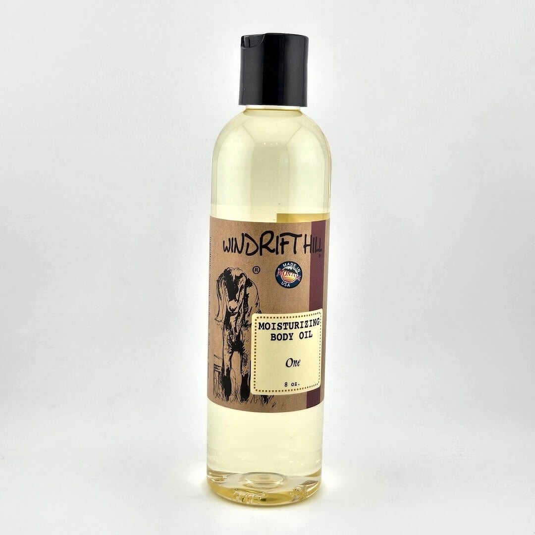 Plastic bottle of Windrift Hill moisturizing body oil on a gray background