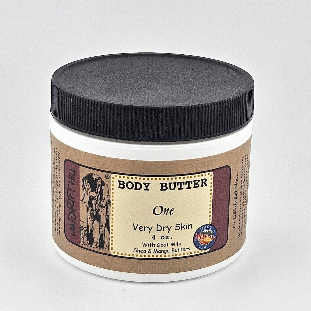 Jar of body butter with a black lid on a gray background