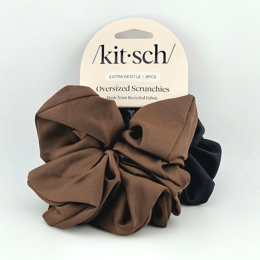 Two oversized scrunchies, one brown and one black, on a white background with 'kitsch' packaging.