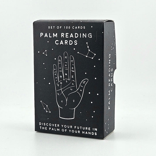 Box of palm reading cards with astrological symbols on a white background