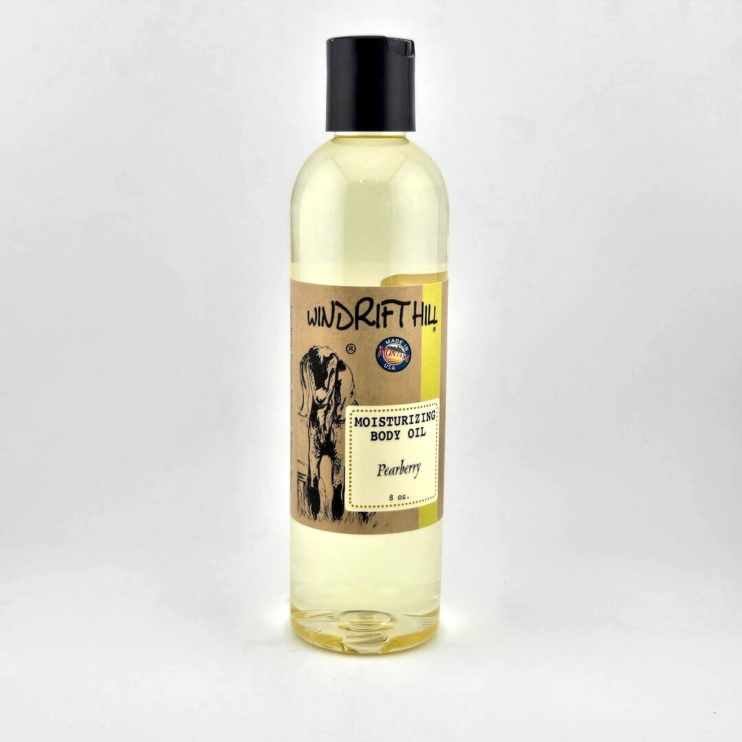Plastic bottle of Windrift Hill moisturizing body oil on a gray background