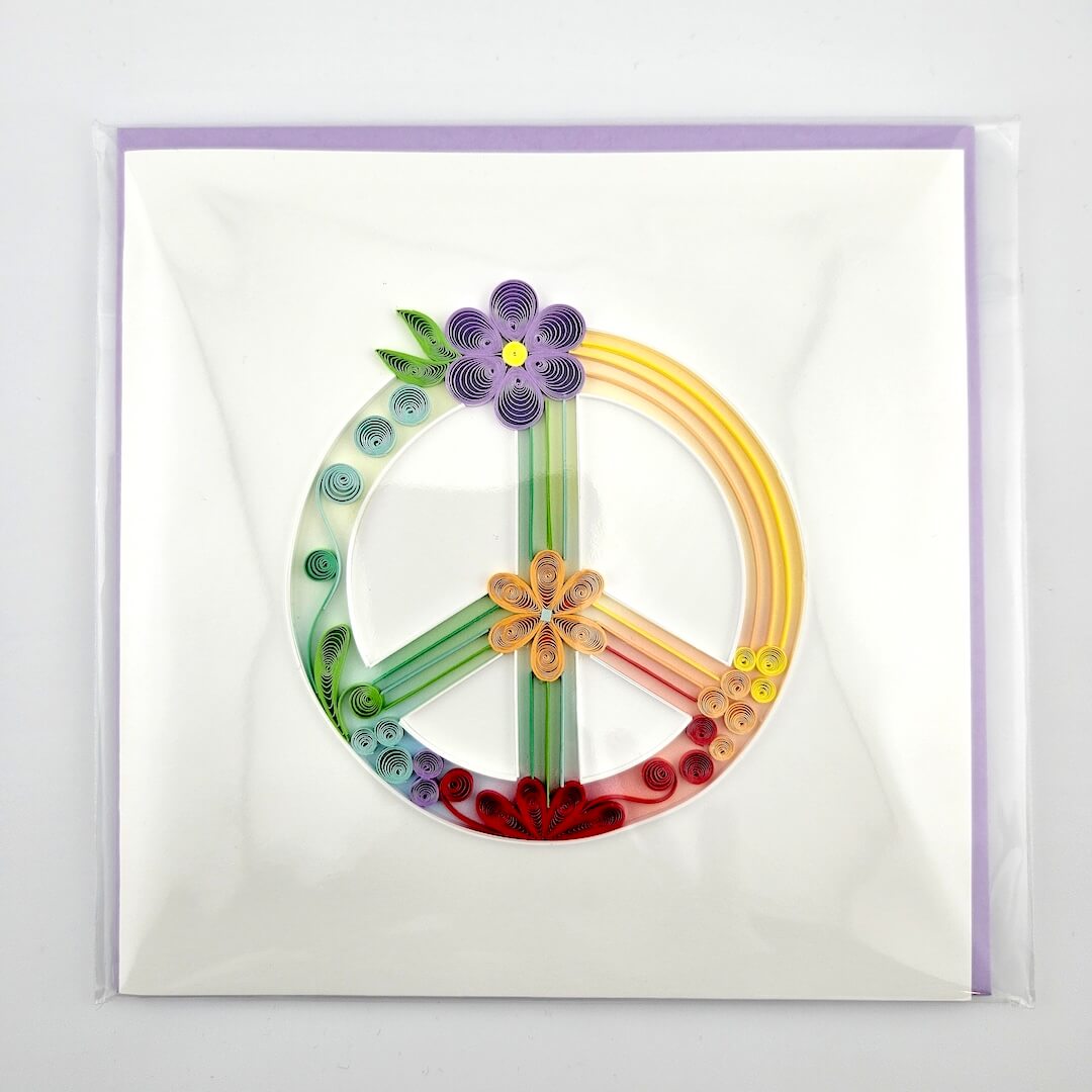 Colorful peace symbol with flowers on a white background