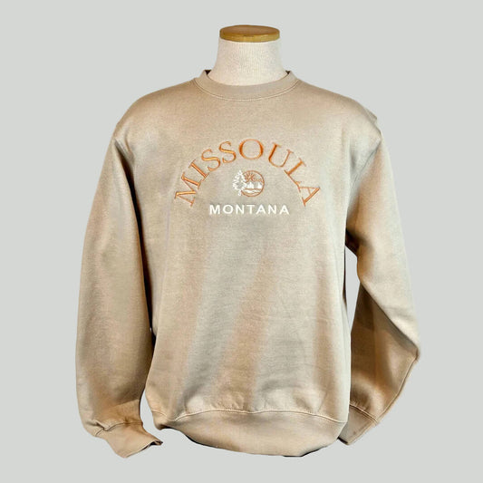 Beige sweatshirt with 'Missoula Montana' text on a mannequin against a white background